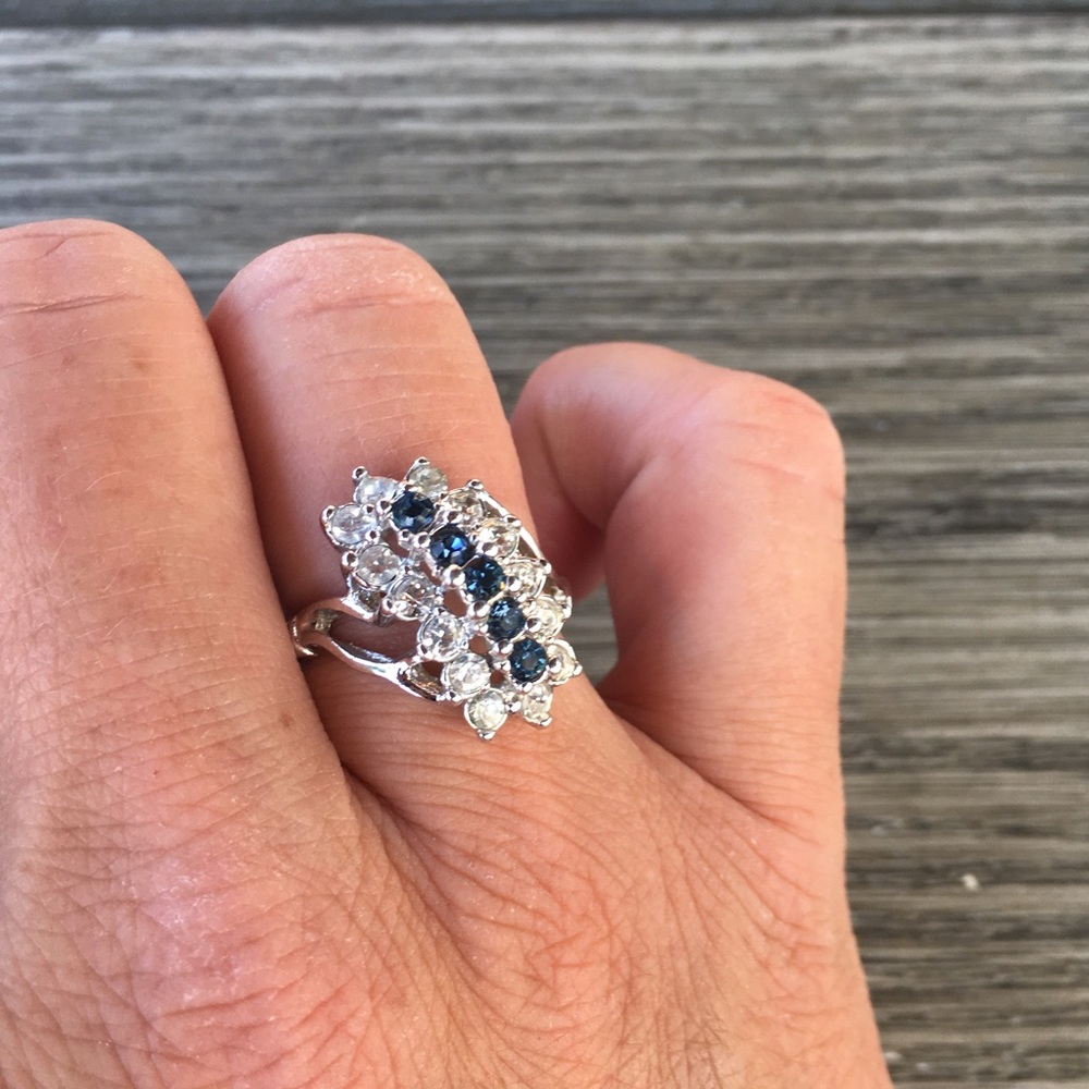 Silver tone ring with blue and white stones